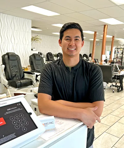 Salon customer using Go Check In tablet at nail salon front desk
