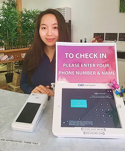 Salon customer using Go Check In tablet at nail salon front desk