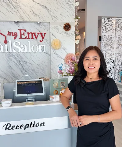 Salon customer using Go Check In tablet at nail salon front desk