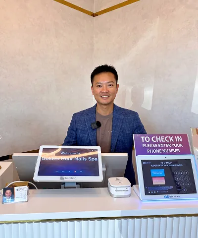 Salon customer using Go Check In tablet at nail salon front desk