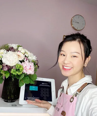 Salon customer using Go Check In tablet at nail salon front desk